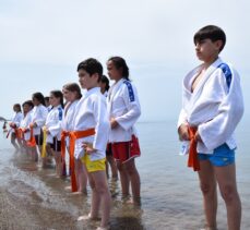 Antrenman için sahile inen küçük judocular denizde yorgunluk atıyor